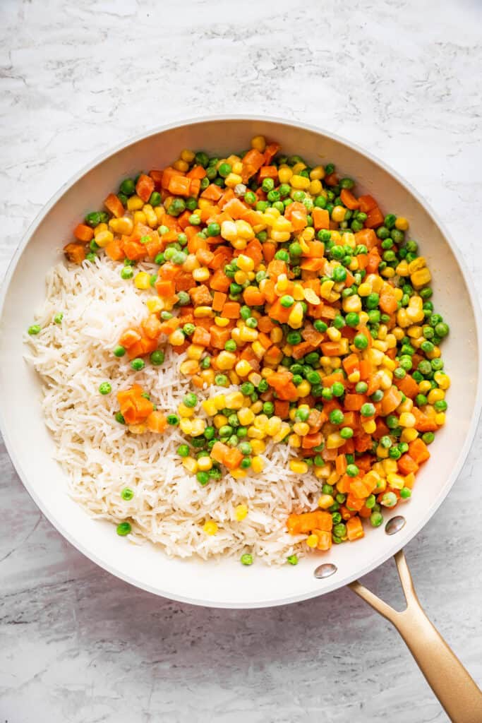 This 10-minute vegetable fried rice is the ultimate quick meal or side dish! Easy, flavorful, and perfect for busy weeknights. Frozen mixed vegetables added to skillet with rice.