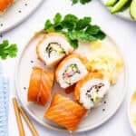 Overhead view of Alaska roll on plate with pickled ginger