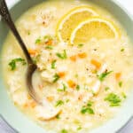 Bowl of avgolemono soup with fresh lemon slices