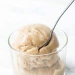 Vanilla banana ice cream in glass bowl with spoon