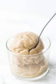 Vanilla banana ice cream in glass bowl with spoon