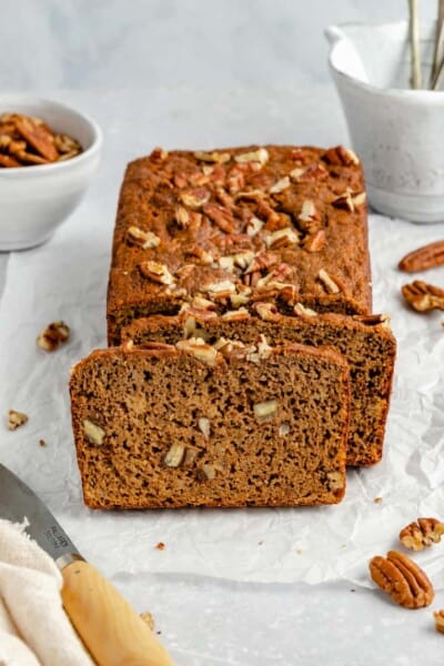 Front view of a loaf of paleo banana bread with slices cut from the end.