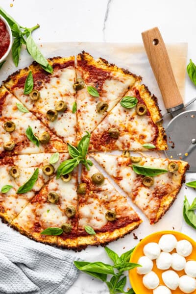 Overhead view of sliced cauliflower crust pizza