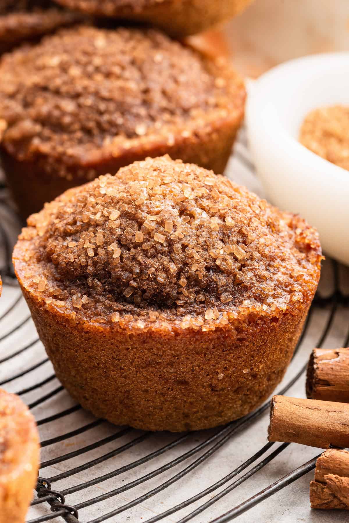 These easy cinnamon muffins are tender, moist, and full of cozy flavor. Healthier than your standard muffin and great for freezing, too! Cinnamon muffins on wire rack