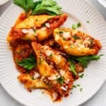 Plate of stuffed shells with spinach.