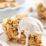 A slice of gluten-free and vegan apple crumb pie topped with ice cream on a plate.