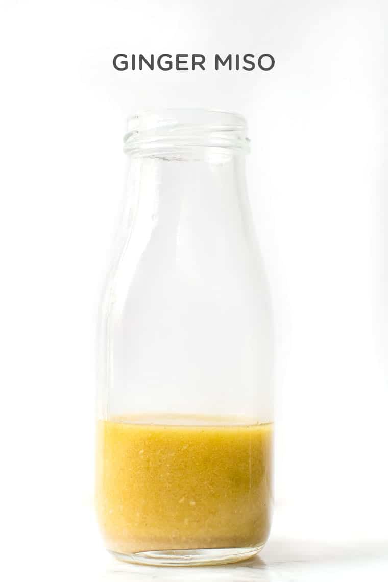 Vegan Ginger Miso Dressing in glass bottle with text overlay