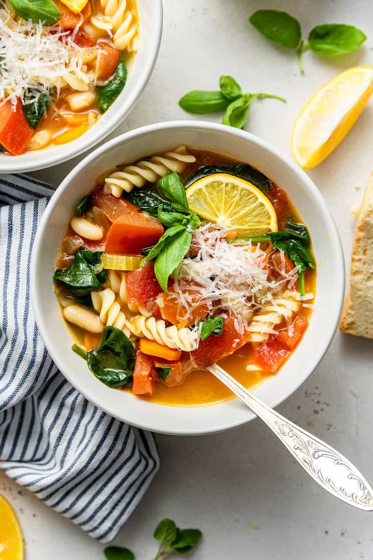 Overhead view of bowl of hearty vegetable stew with parmesan