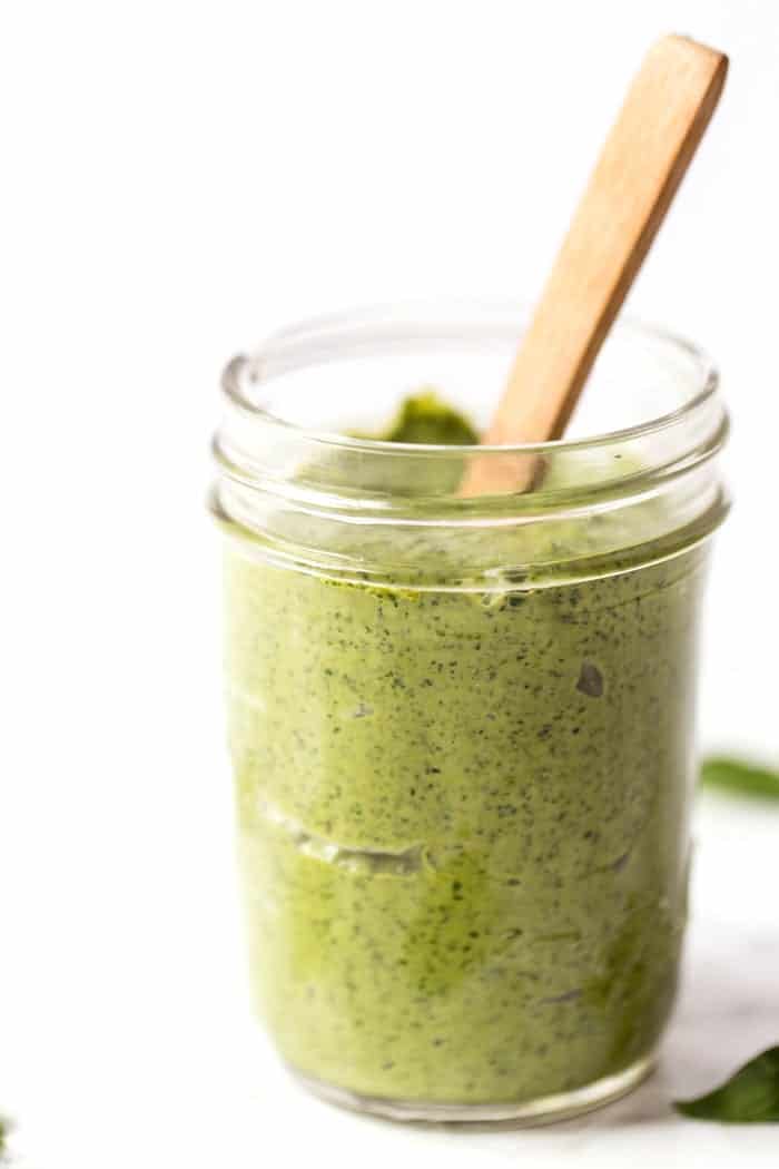This one-pot asparagus pasta recipe is the best kind of weeknight dinner—easy and delicious! Pesto adds bright, fresh flavor. Creamy pesto in jar with spoon