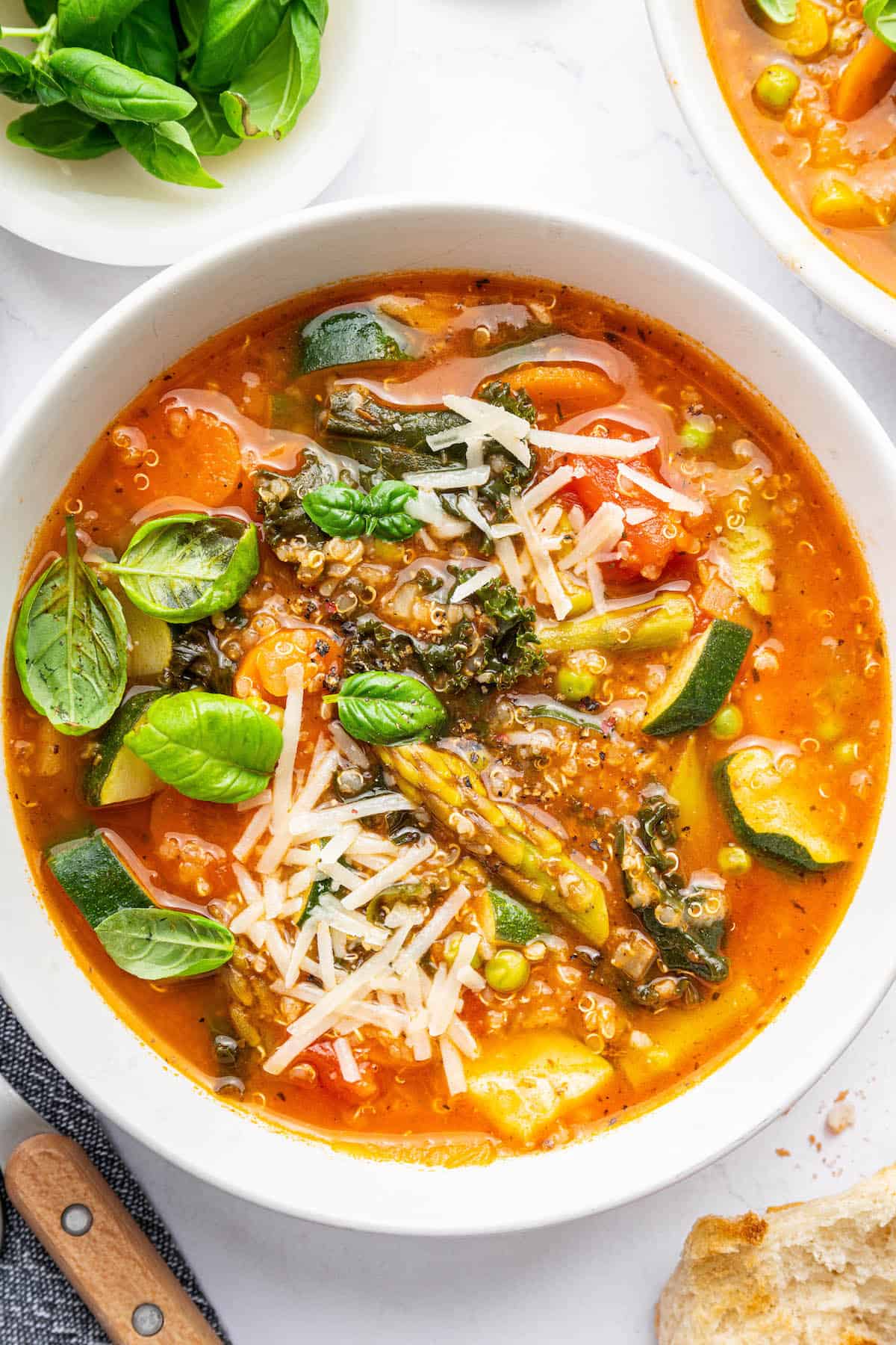 This vegetarian minestrone soup is packed full of fresh vegetables and makes for the most delicious weeknight meal. Easy and so satisfying! Top down view of vegetarian minestrone soup in bowl