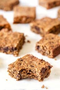 Peanut butter oatmeal bars on countertop with one bar bitten