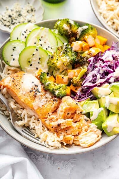 Top-down view of salmon power bowl with fork
