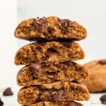 Stack of vegan chocolate chip cookies cut in half to show thick, chewy texture.