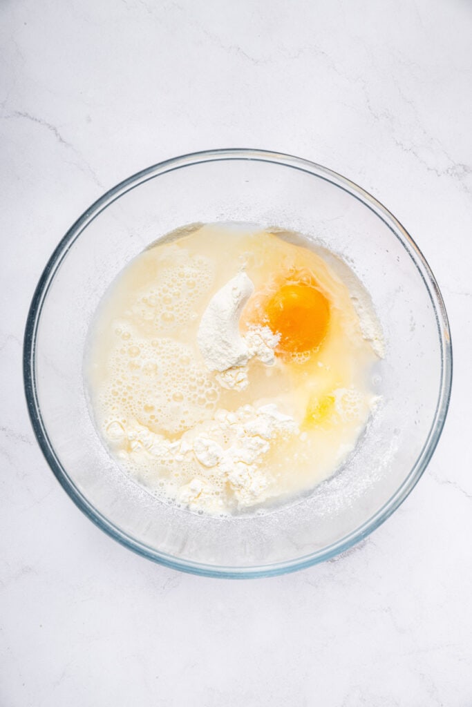 Dredge them in cornstarch. Generously sprinkle cornstarch on your shrimp until they’re completely covered. Shake off any excess. Ingredients for shrimp tempura batter in bowl before whisking