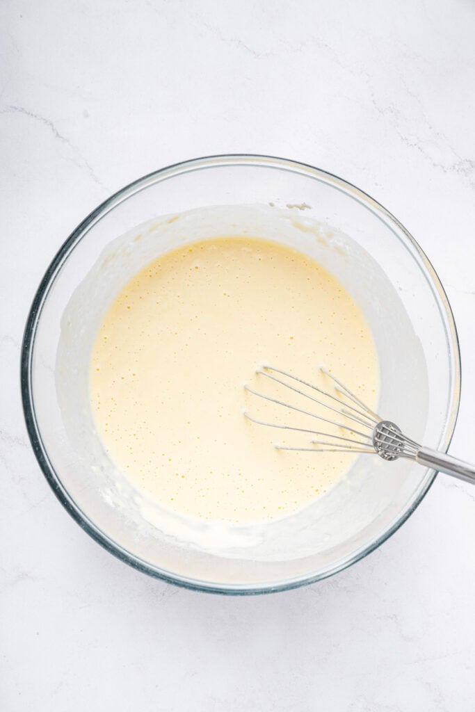Dredge them in cornstarch. Generously sprinkle cornstarch on your shrimp until they’re completely covered. Shake off any excess. Bowl of tempura batter with whisk