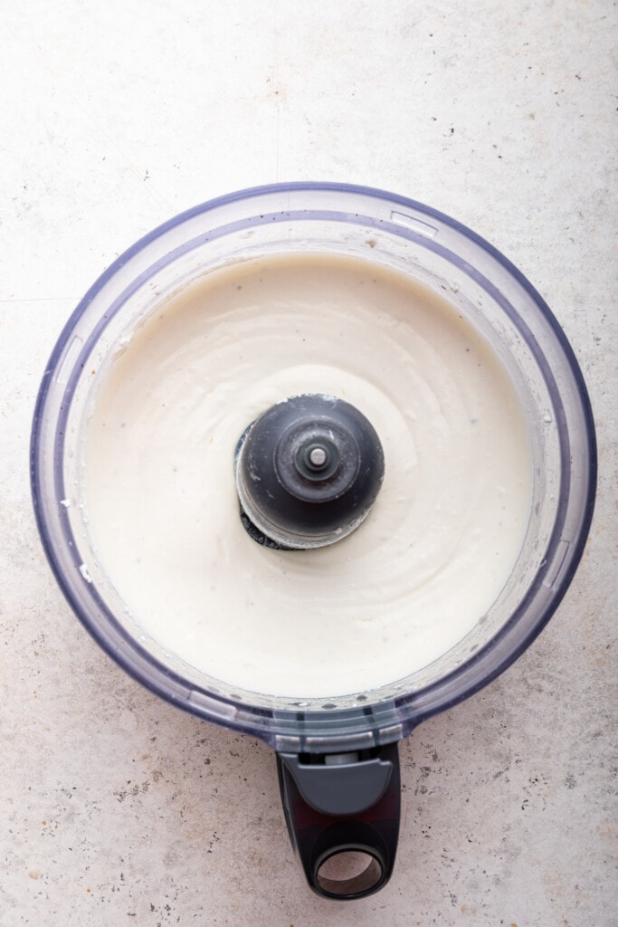 Love the protein but hate the curds? Whipped cottage cheese gives you the nutrition without the texture. Two easy versions: sweet & savory! Overhead view of savory whipped cottage cheese in food processor