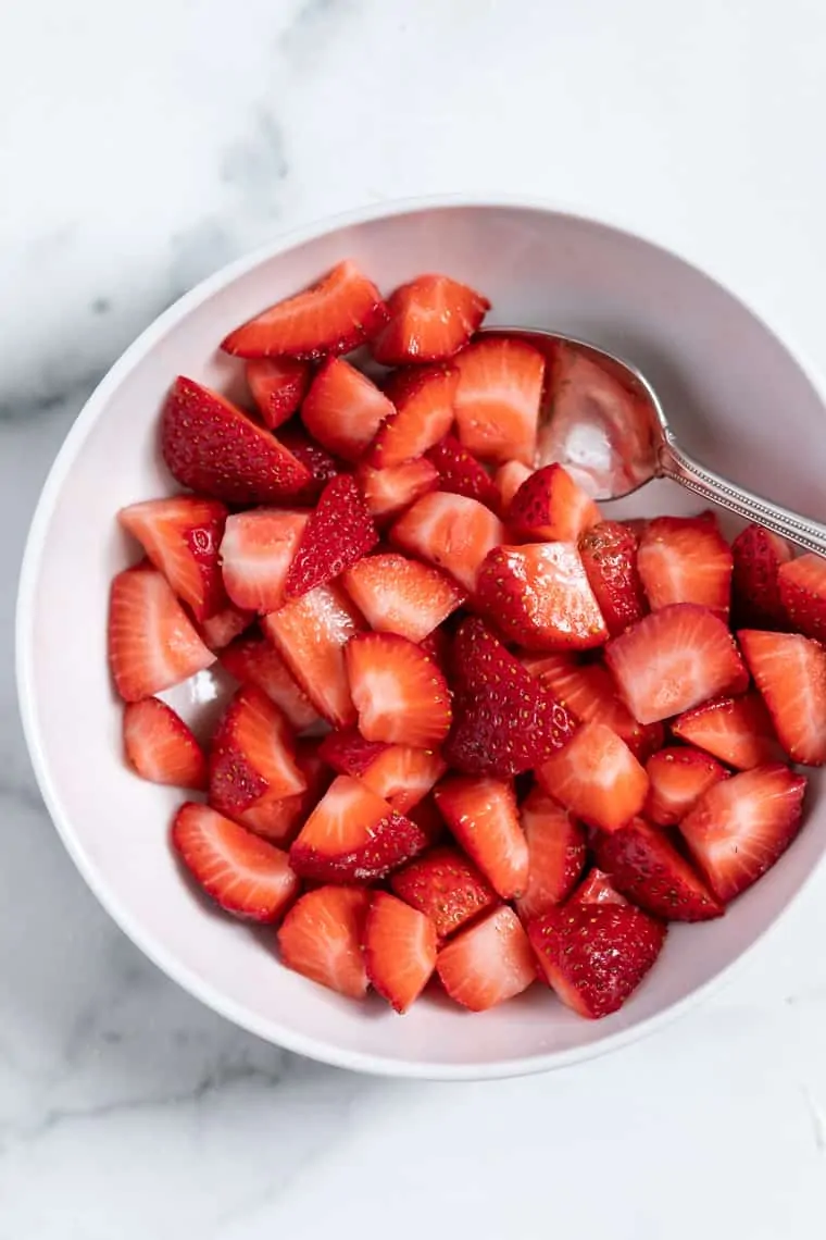 A collection of the best berry recipes—smoothies, breakfasts, salads, desserts and more! Plus tips + tricks for berry picking and storage. Bowl of strawberries with spoon