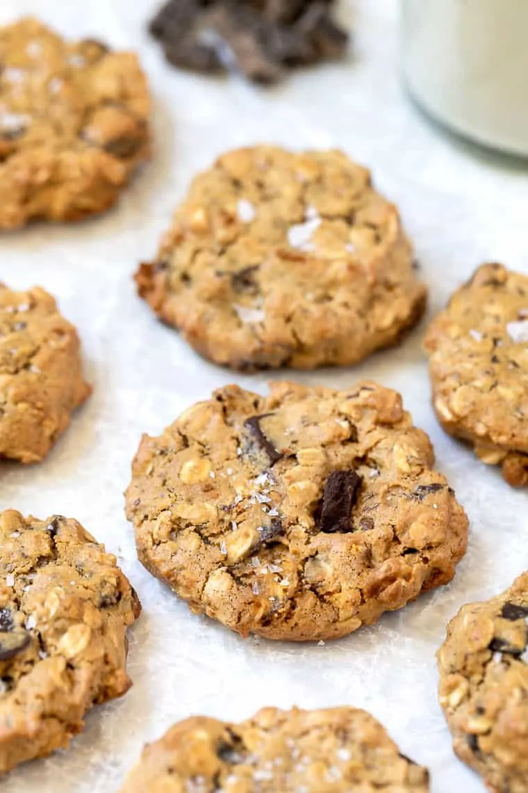 With chewy middles, crispy edges and chocolate in every bite, these gluten-free vegan oatmeal chocolate chip cookies are the best ever! Vegan oatmeal chocolate chip cookies with sea salt sprinkled on top.