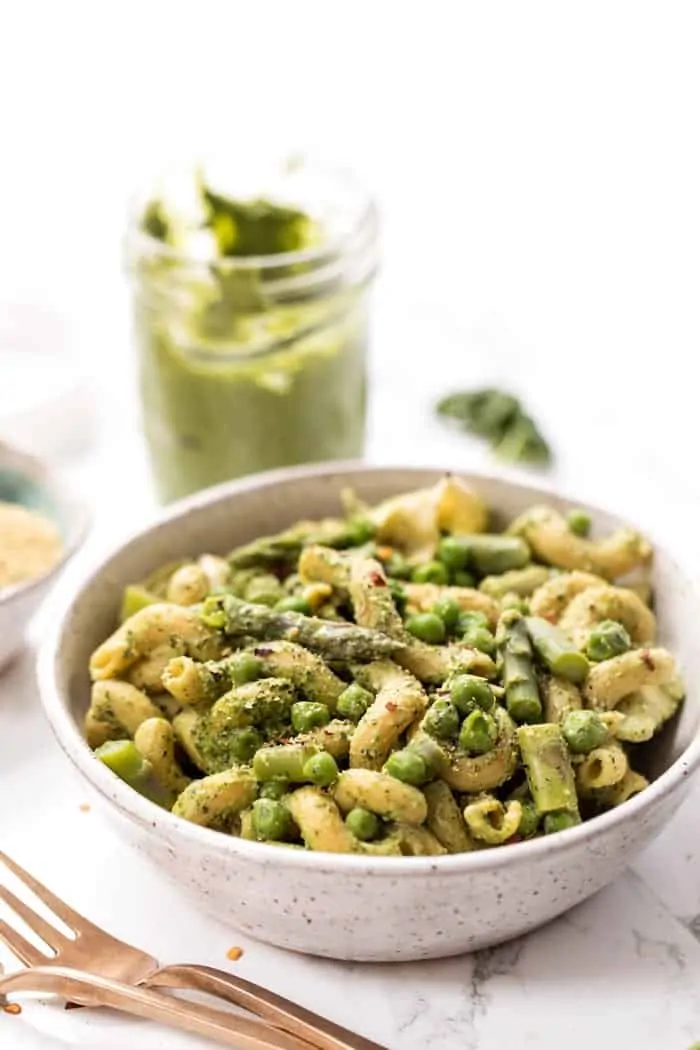 This one-pot asparagus pasta recipe is the best kind of weeknight dinner—easy and delicious! Pesto adds bright, fresh flavor. Bowl of asparagus pasta with pesto and peas