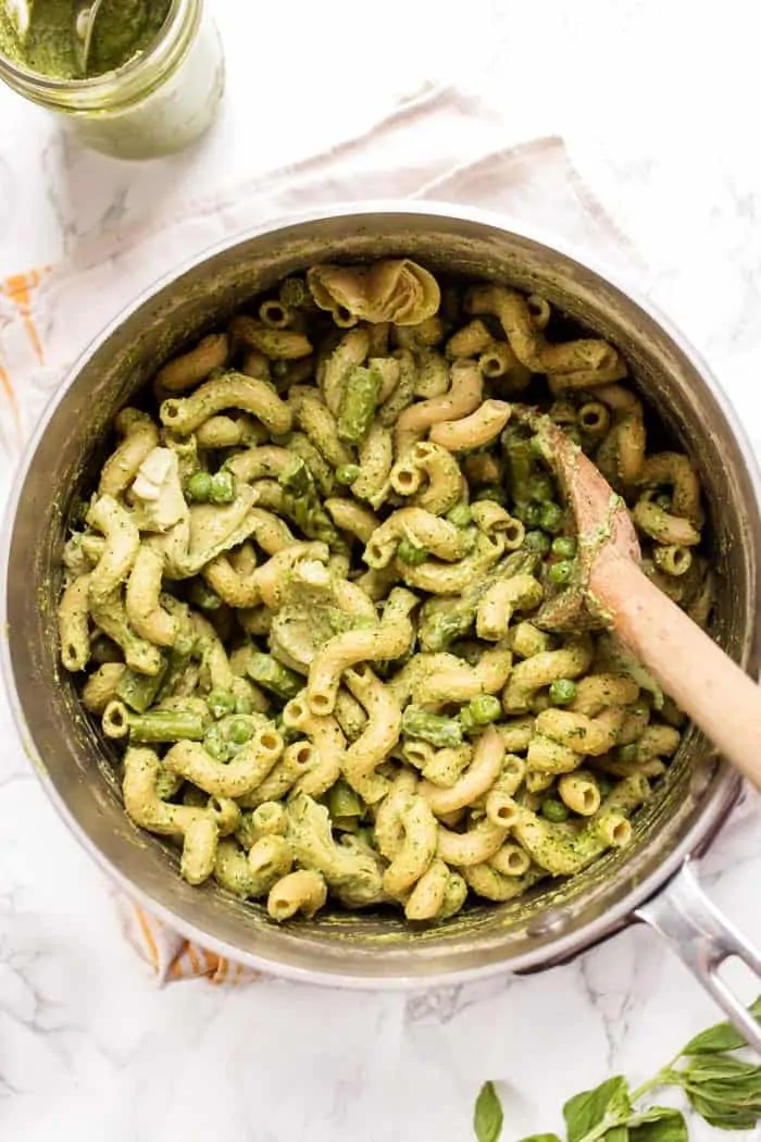 This one-pot asparagus pasta recipe is the best kind of weeknight dinner—easy and delicious! Pesto adds bright, fresh flavor. Overhead view of creamy pesto asparagus pasta in pot